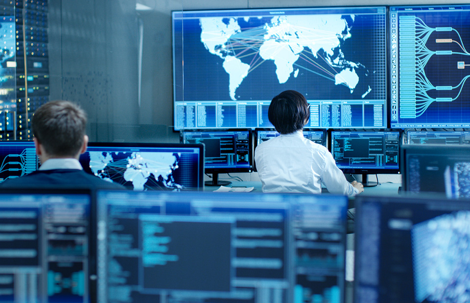 Staff in front of monitors in Train Control Center