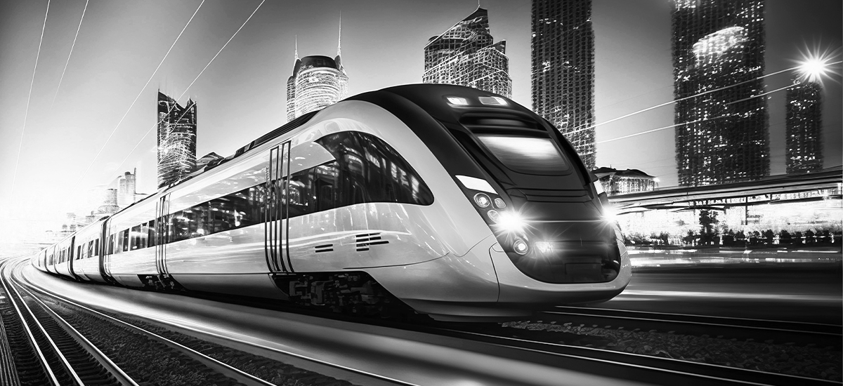 High-speed train entering a station with blurred city in the background